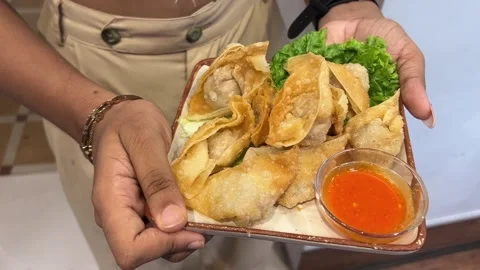 Chicken fried wanton - Crispy fried dumplings filled with savory ingredients Stock-Footage 315129293