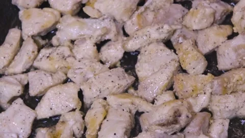 Chicken in a frying pan close-up plan. Roasting meat close-up Stock Footage 232023618
