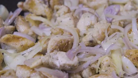 Chicken in a frying pan close-up plan. Roasting meat close-up Stock Footage 232274034