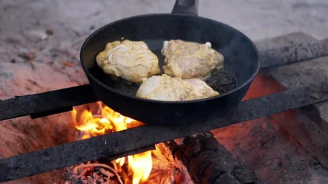 Chicken Frying in Pan on Open Fire Stock Footage 293184406