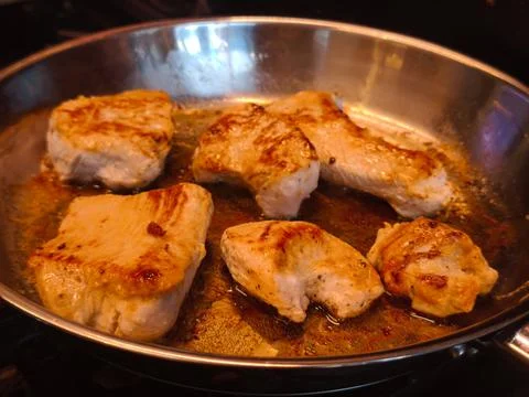 Chicken frying in the pan Stock Photos
