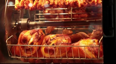 Chicken grill rotating on a skewer Stock Footage 55694111