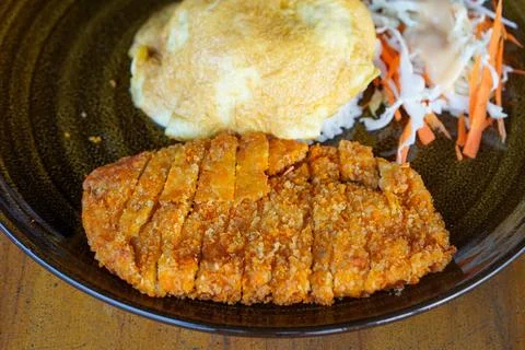 Chicken katsu curry omurice with fluffy omelet over steamed rice Stock Photos