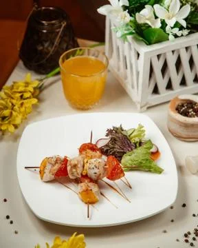 Chicken kebab with vegetables on the table Stock Photos