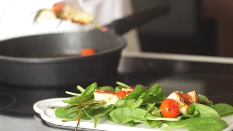 Chicken kebabs served with tomato cherry and greenery on a white chopping board Stock Footage 112049949
