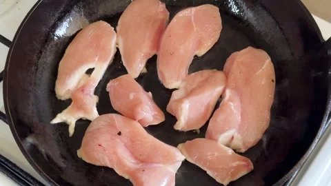 Chicken Lean Meat Frying In A Pan At Home. High Angle Shot Stock Footage 317553909