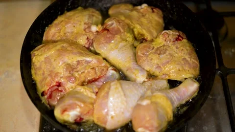 Chicken legs are fried in a large skillet in vegetable oil. Top view of grilled Stock Footage 149000286