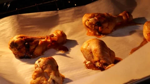 Chicken legs baking in oven on baking paper Stock Footage 306236180