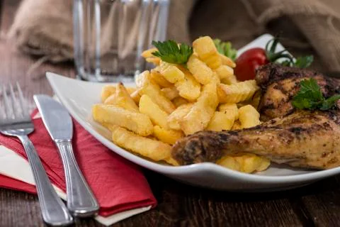 Chicken legs with chips Stock Photos