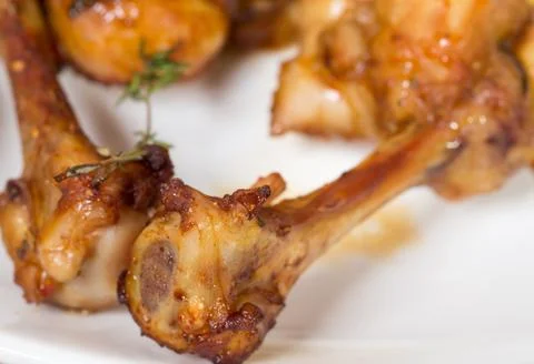 Chicken legs with melted cheese. Stock Photos