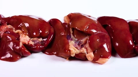 Chicken liver on white background, rotating Video stock 323575075