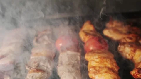 Chicken, meat and liver kebabs are fried on an open grill with charcoal Stock Footage 280461663
