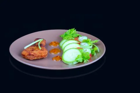 Chicken meat fried in a breaded with fresh vegetables 写真素材