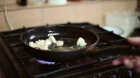 Chicken meat is fried in a frying pan and lights a fire Stock Footage 59699448