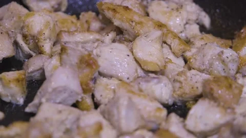 Chicken meat is fried in a pan. Roasting chicken meat. home cooking Stock Footage 232023801