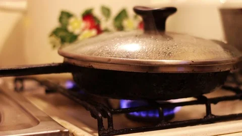Chicken meat is fried under a transparent lid Stock Footage