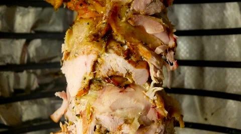 Chicken meat on the metal skewer rotating for doner kebab Stock Footage 59185605