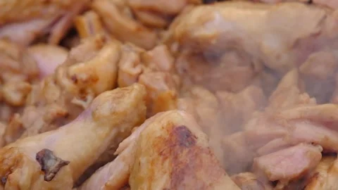 Chicken meat is stewed in a cauldron. A dish on a fire in a cauldron. The meat Stock Footage 307313848
