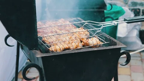Chicken meat that turn over on a barbecue grill.Meat is fried in Mangal Barbecue Stock Footage