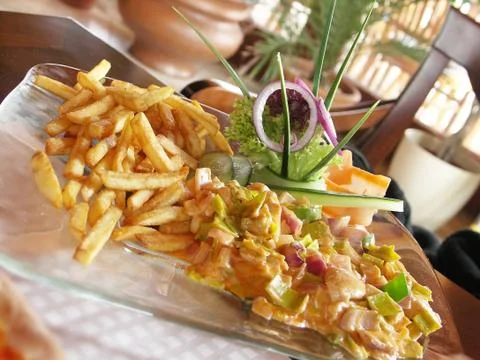 Chicken mixture with chips and vegetables Stock Photos