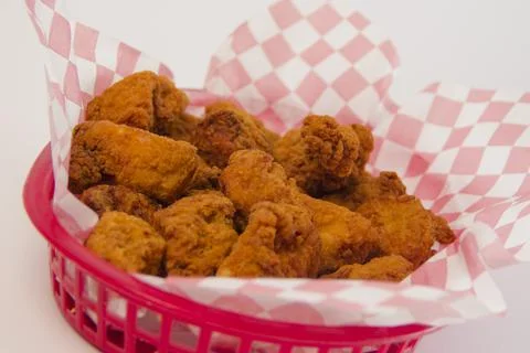 Chicken nuggets basket with checkered pattern paper on a white background Stock Photos