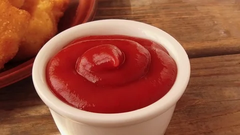 Chicken nuggets in breading are dipped in tomato sauce Stock Footage 79361918