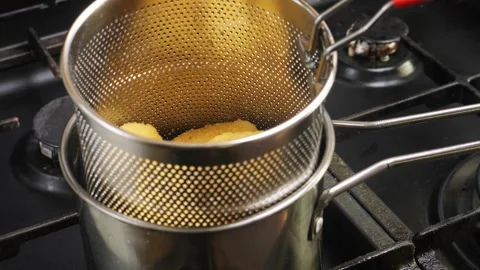 Chicken nuggets in a deep-fat grid are fried in boiling oil Stock Footage 306548589
