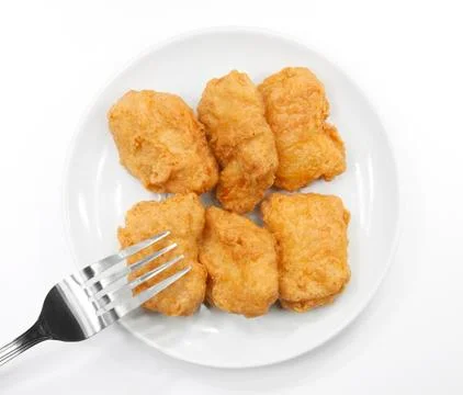 Chicken nuggets with fork on white plate Stock Photos