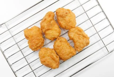 Chicken nuggets on grille Stock Photos