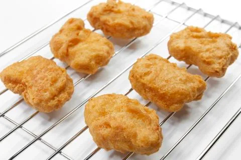 Chicken nuggets on grille Stock Photos