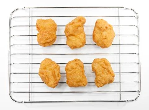 Chicken nuggets on grille Stock Photos