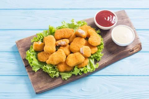 Chicken nuggets in plate on rustic background Stock Photos