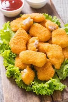 Chicken nuggets in plate on rustic background Stock Photos