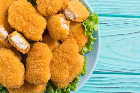 Chicken nuggets in plate on rustic background Stock Photos