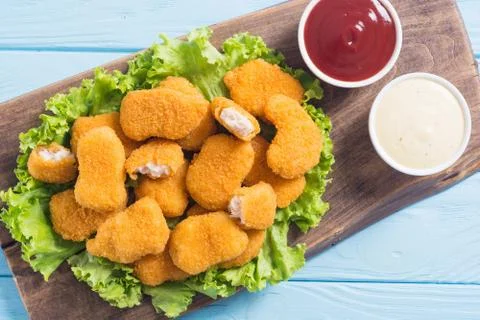 Chicken nuggets in plate on rustic background Stock Photos