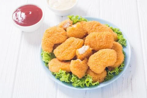 Chicken nuggets in plate on rustic background Stock Photos