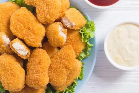 Chicken nuggets in plate on rustic background Stock Photos