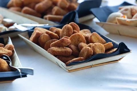 Chicken nuggets served on a tray at a buffet presenting various finger foods Photos