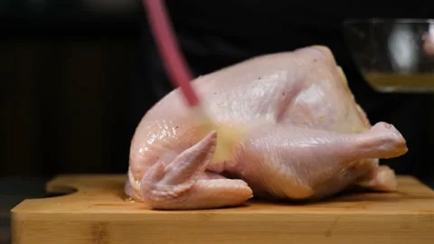 The chicken is oiled before baking Video stock 190325399