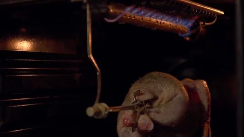 The chicken in the oven roasting on a spit. Stock Footage 69095135