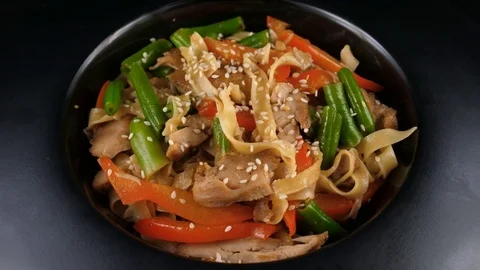 Chicken pasta with vegetables, served with chicken fillet, asparagus, tomatoes Video stock 80755455