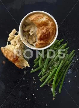 A chicken pie with green beans Stock Photos