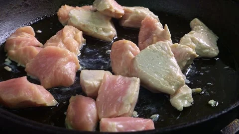 Chicken pieces are fried in vegetable oil, hot frying pan. Medium shot. Video stock 306249591