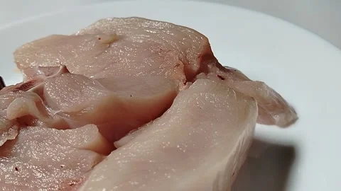 Chicken pieces on a plate, a basic ingredient in a food menu. Video stock 329466423