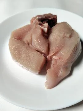 Chicken pieces on a plate, a basic ingredient in a food menu. Фото