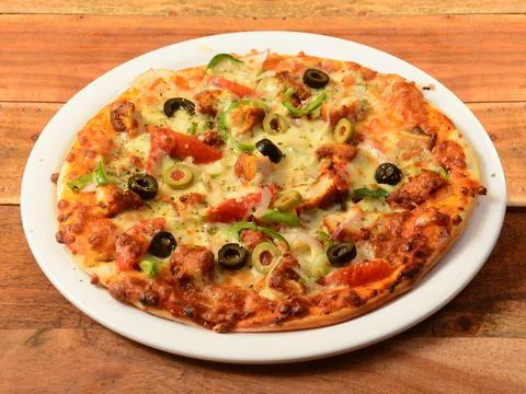 Chicken Pizza isolated over a rustic wooden background, selective focus Stock Photos