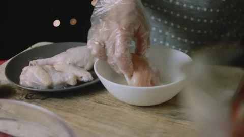 Chicken portion turned through foamy egg coating Stock Footage 342128132