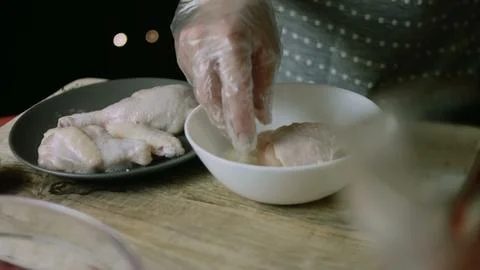 Chicken portion turned through foamy egg coating Stock Photos