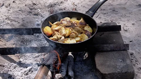 Chicken with potatoes cooked on fire Stock Footage 293275416
