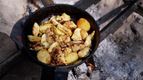 Chicken with potatoes is fried in a pan on fire Stock Footage 293272995